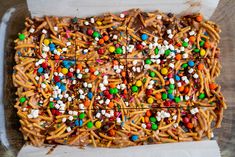 a tray filled with lots of candy covered pretzels