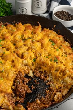 a casserole dish with meat and cheese in it