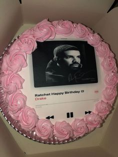 a cake with pink frosting in the shape of a man's face on it