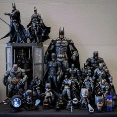 a group of batman figurines sitting on top of a table