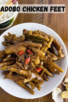 chicken feet addbo on a white plate with rice and chopsticks in the background