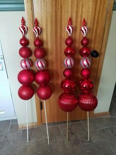 red and white ornaments on sticks in front of a door