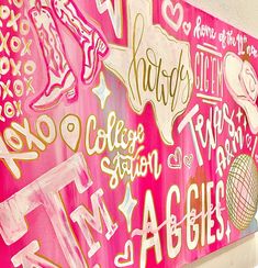 a pink wall with many different types of writing on it and the word college station written in gold