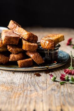 there are some pieces of bread stacked on a plate with jam in the middle and flowers around it