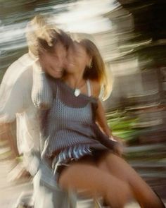 a young man and woman riding a skateboard