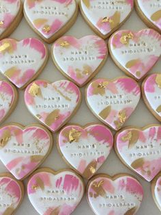 heart shaped cookies decorated with pink and gold paint