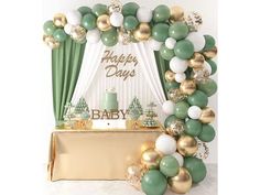 a baby shower is decorated with balloons and green, white and gold decorations for the baby's first birthday