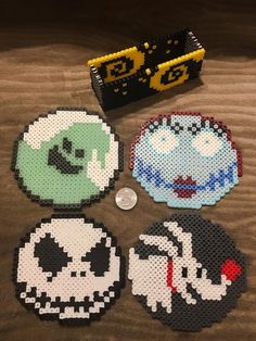 four pieces of perler bead art on a table