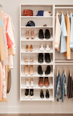 an organized closet with shoes and clothing hanging on the wall next to shelves filled with clothes