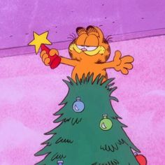 garfield the cat standing on top of a christmas tree