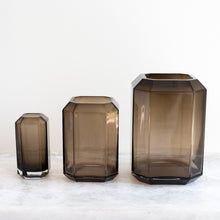 three brown vases sitting on top of a white table