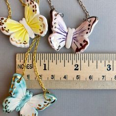 "This listing is for one hand made ceramic butterfly pendant necklace. A perfect gift to bring some sunshine , butterflies carry a message and symbolism of rebirth, transformation, joy, and tapping into the miracle of life in the present moment. Each pendant is hand-sculpted and glazed so no two will ever be exactly alike! Just about an 1.5\" with shiny glasslike glaze and enhanced by real 22k gold or white gold accents. Butterflies are set on an 18\" chain, in gold-plated or silver or finish.* Top Ear Piercing, Ceramic Butterfly, Necklace Ceramic, Handmade Pendant Necklace, Bow Necklace, Butterfly Pendant Necklace, Ceramic Earring, Tiny Earrings, Cat Earrings