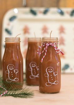 three glass jars with gingerbreads drawn on them