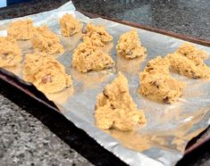 some cookies are sitting on a baking sheet and ready to be baked in the oven