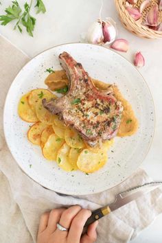 Enjoy the rich flavors of Spanish-style pork chops with garlic-parsley marinade, roasted potatoes, and a savory onion sauce!