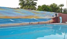 a large mural on the side of a swimming pool