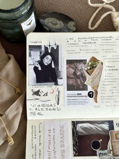 an open book with pictures and writing on it next to a jar of candles, some other items