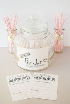 two pink and white striped straws in a jar next to some paper napkins