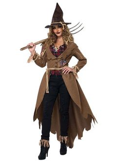 a woman dressed as a scarecrow holding a pitchfork