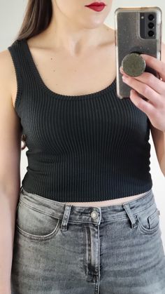 Details: You will love this two tone black and charcoal ribbed scoop neck tank top! Soft stretchy material and a good length for a crop top. So versatile! Pair with your favorite high waisted pants. Materials: 72% Polyester, 23% Rayon, 5% Spandex Made In: USA Sizing Tip: Order True to Size. If in between sizes then size up. I am about 5'7 165 pounds and a 34B, and I am generally a S/M top, and I am wearing the medium.