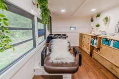 the inside of a hair salon with lots of natural greenery on the windowsill