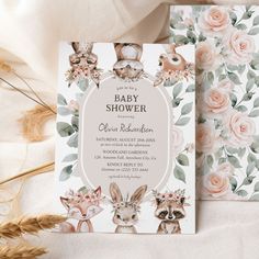 two baby shower cards with pink roses and deer heads on them, sitting next to each other