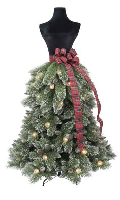 a christmas tree with a red and green ribbon tied around it's neck, on top of a mannequin