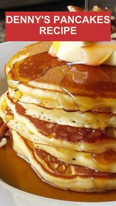 a stack of pancakes sitting on top of a white plate covered in syrup and butter