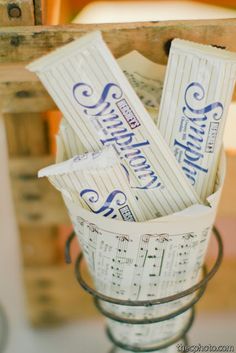 a bucket filled with music notes sitting on top of a table