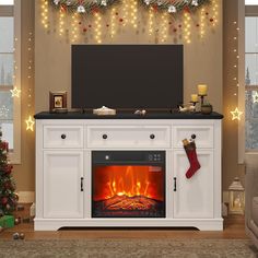 a living room with a fireplace and christmas stockings on the mantle, decorated with lights