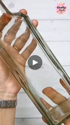 a person holding a glass bottle with water in it's palm and thumbnails