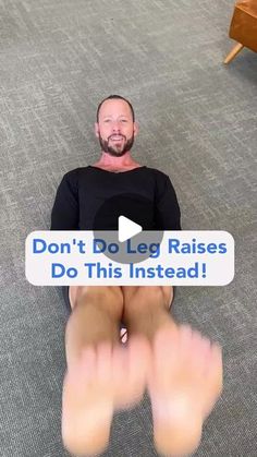 a man sitting on the floor with his feet up and texting don't do leg raises do this instead