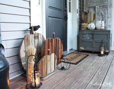 the front porch is decorated for halloween with pumpkins, brooms and other decorations