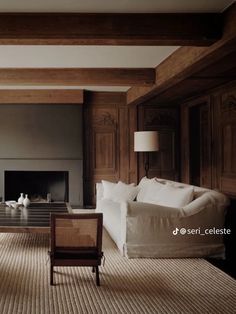 a large living room with wood paneling and white furniture