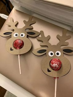 two reindeer lollipops are sitting on a table