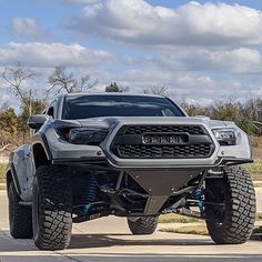 a large gray truck parked on the side of a road