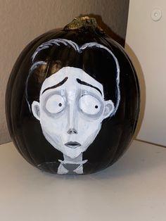 a painted pumpkin with a man's face on it