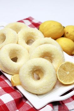 there are lemons and donuts on the plate