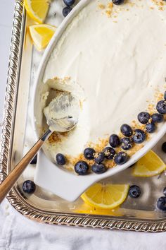 a serving dish filled with lemon and blueberries