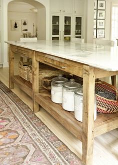 a kitchen island with lots of jars on it