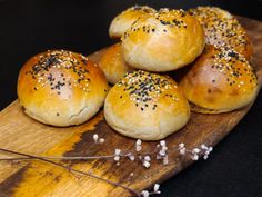 small rolls with sprinkles on a wooden cutting board