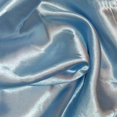 a close up view of a shiny blue fabric