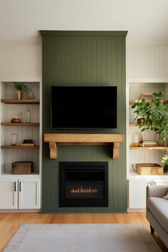 a living room with a fireplace and tv mounted on the wall above it's mantle