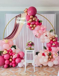 the balloon arch is decorated with pink, gold and white balloons for an elegant birthday party