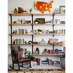 a living room filled with lots of furniture and bookshelves covered in shelves next to a rug