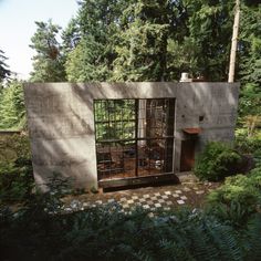 a concrete structure with glass doors in the middle