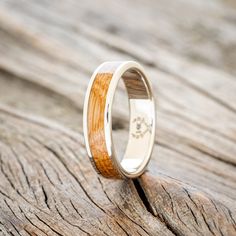 a wedding ring with a wooden inlay