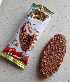 a bag of nuts next to a half eaten chocolate bar on a counter top with a bite taken out of it