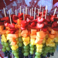 fruit skewers with strawberries, grapes, and melon on them are ready to be eaten