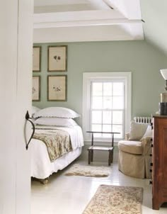 an image of a bedroom with green walls and white bed for calmness in the room